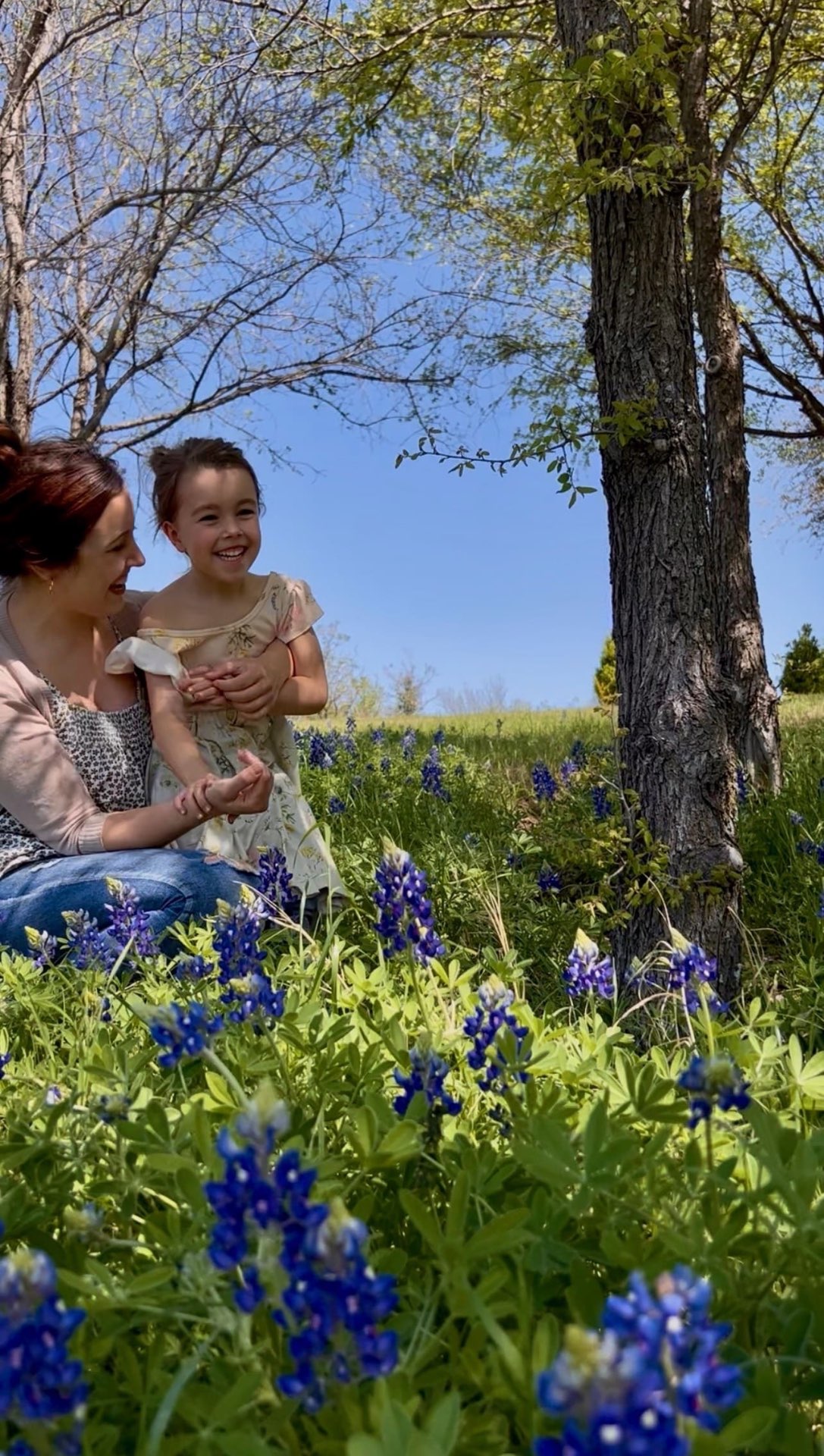 Alyssa and her daughter laughing in a Texas meadow